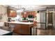 Well-equipped kitchen boasting stainless steel appliances, wood cabinets, and a modern design at 8035 Black Oak Ct, Plainfield, IN 46168