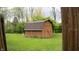 A wooden shed has a brown roof and is surrounded by grass and trees at 8035 Black Oak Ct, Plainfield, IN 46168