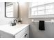 Modern bathroom with a black faucet, white vanity, and bright natural light at 8142 Bittern Ln, Indianapolis, IN 46256