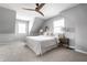 Serene bedroom featuring neutral tones, a wood ceiling fan, and bright natural light at 8142 Bittern Ln, Indianapolis, IN 46256