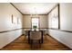 Warm dining room with hardwood floors, natural light, and modern chandelier at 8142 Bittern Ln, Indianapolis, IN 46256