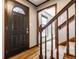 Welcoming foyer featuring hardwood floors, staircase with carpet, and door with decorative glass at 8142 Bittern Ln, Indianapolis, IN 46256