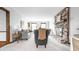 Bright living room with exposed brick fireplace, neutral carpet, light walls, and modern decor at 8142 Bittern Ln, Indianapolis, IN 46256