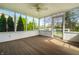 Screened porch with wood flooring, a ceiling fan, and views of the green backyard at 8142 Bittern Ln, Indianapolis, IN 46256