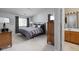 Cozy bedroom featuring soft gray walls, a comfortable bed, and an adjoining bathroom at 8410 Glenwillow Ln # 208, Indianapolis, IN 46278