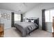 Comfortable bedroom featuring soft gray walls, a comfortable bed, and large windows at 8410 Glenwillow Ln # 208, Indianapolis, IN 46278