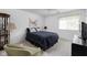 Guest bedroom featuring a dark blue bedspread and comfortable chair at 8410 Glenwillow Ln # 208, Indianapolis, IN 46278
