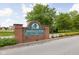 Inviting brick sign for Hidden Creek Condominiums, a Hills Community, set amongst lush greenery and mature trees at 8410 Glenwillow Ln # 208, Indianapolis, IN 46278