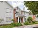 Inviting condo exterior featuring stylish siding, brick accents, and manicured landscaping at 8410 Glenwillow Ln # 208, Indianapolis, IN 46278