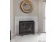 Close-up view of the fireplace with classic tile and decorative screen at 8410 Glenwillow Ln # 208, Indianapolis, IN 46278