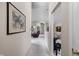 Bright hallway showcasing artwork leading to a spacious living area at 8410 Glenwillow Ln # 208, Indianapolis, IN 46278