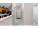 Hallway view leading to the kitchen showcasing black appliances and plenty of counter space at 8410 Glenwillow Ln # 208, Indianapolis, IN 46278