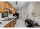 Functional kitchen featuring classic cabinetry, black appliances, and bright lighting at 8410 Glenwillow Ln # 208, Indianapolis, IN 46278