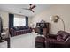 Inviting living room with comfortable seating, a desk area, and a modern ceiling fan at 8410 Glenwillow Ln # 208, Indianapolis, IN 46278