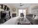 Bright living room features a fireplace and access to outdoor balcony with seating at 8410 Glenwillow Ln # 208, Indianapolis, IN 46278