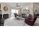Inviting living room features a cozy fireplace and access to outdoor balcony at 8410 Glenwillow Ln # 208, Indianapolis, IN 46278