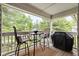 Outdoor patio with seating and a grill, perfect for enjoying the surrounding greenery at 8410 Glenwillow Ln # 208, Indianapolis, IN 46278