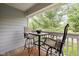 Outdoor patio with seating, offering a view of the surrounding trees and greenery at 8410 Glenwillow Ln # 208, Indianapolis, IN 46278