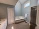 Bathroom featuring a jacuzzi tub, a shower, and a window with a view for relaxation at 8502 Jib Ct, Indianapolis, IN 46236