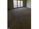 Large carpeted room with a sliding glass door leading to a deck, ready for personalization at 8502 Jib Ct, Indianapolis, IN 46236