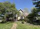 Charming brick home with mature trees and lush landscaping creating a welcoming curb appeal at 8502 Jib Ct, Indianapolis, IN 46236