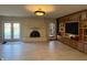 Open living room with a fireplace, built-in shelving, and a view of the backyard pool at 8502 Jib Ct, Indianapolis, IN 46236
