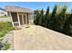 Backyard featuring a charming shed with concrete space, enhanced by lush green trees and shrubbery at 8830 Kipling Dr, Indianapolis, IN 46239