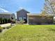 Spacious backyard with a well-maintained lawn, mature landscaping, and a hot tub, perfect for outdoor enjoyment at 8830 Kipling Dr, Indianapolis, IN 46239