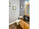 Charming powder room with a vessel sink and modern fixtures, perfect for guests at 8830 Kipling Dr, Indianapolis, IN 46239