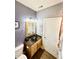 Cozy powder room featuring a vessel sink, light fixtures, and framed mirror, an ideal guest space at 8830 Kipling Dr, Indianapolis, IN 46239