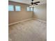 Spacious bedroom with ceiling fan and carpet, filled with natural light from the windows at 8830 Kipling Dr, Indianapolis, IN 46239