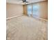 This large bedroom features plush carpeting, a ceiling fan, and two large windows at 8830 Kipling Dr, Indianapolis, IN 46239