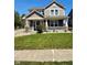 Charming two-story home featuring a covered front porch and well-manicured lawn at 8830 Kipling Dr, Indianapolis, IN 46239