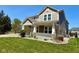 Beautifully landscaped front yard with a charming two-story home and inviting covered porch at 8830 Kipling Dr, Indianapolis, IN 46239