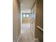 Hallway with carpet, leading to the bedroom with natural light from the small windows at 8830 Kipling Dr, Indianapolis, IN 46239