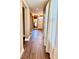 Hallway with wood-look floors and a view of the front door at 8830 Kipling Dr, Indianapolis, IN 46239