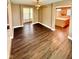 Open floor plan features vinyl flooring, ceiling fan, and an island in the kitchen at 8830 Kipling Dr, Indianapolis, IN 46239