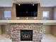 Living room features a stone fireplace with a large flatscreen TV above the mantel at 8830 Kipling Dr, Indianapolis, IN 46239
