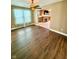 Living room boasts vinyl flooring, a ceiling fan, and an archway to the fireplace at 8830 Kipling Dr, Indianapolis, IN 46239