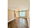 Bright living room with vinyl flooring, a ceiling fan, and a large window at 8830 Kipling Dr, Indianapolis, IN 46239
