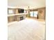 Bright living room featuring a stone fireplace, ceiling fan and a large window at 8830 Kipling Dr, Indianapolis, IN 46239