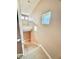 Carpeted staircase with natural light, leading to the main level, providing easy access at 8830 Kipling Dr, Indianapolis, IN 46239