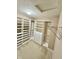 This walk-in closet is complete with built-in shelving and drawers at 8830 Kipling Dr, Indianapolis, IN 46239