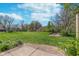 Lush green backyard with mature trees and a concrete drainage structure at 9162 Cinnebar Dr, Indianapolis, IN 46268