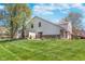 Exterior shot of a home with a grassy lawn and mature trees in the backyard at 9162 Cinnebar Dr, Indianapolis, IN 46268