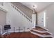 Inviting entryway with hardwood floors, white staircase, and stylish pendant lighting at 9162 Cinnebar Dr, Indianapolis, IN 46268