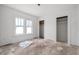 A bright bedroom features large windows and closet spaces ready for customization at 940 N Chester Ave, Indianapolis, IN 46201