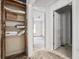 A hallway showcases an open closet and a view to a bright room, capturing the potential of the space at 940 N Chester Ave, Indianapolis, IN 46201