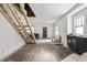 Spacious living room featuring an unfinished staircase, ready for renovation and personal touch at 940 N Chester Ave, Indianapolis, IN 46201