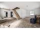 Open concept living room featuring unfinished staircase and ample natural light at 940 N Chester Ave, Indianapolis, IN 46201